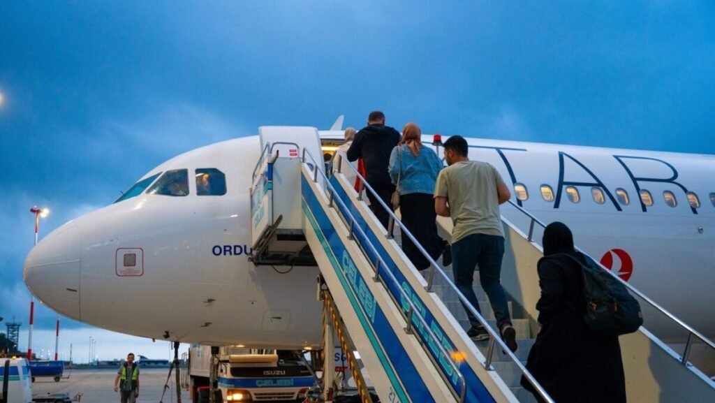 Passengers boarding an airplane at an airport